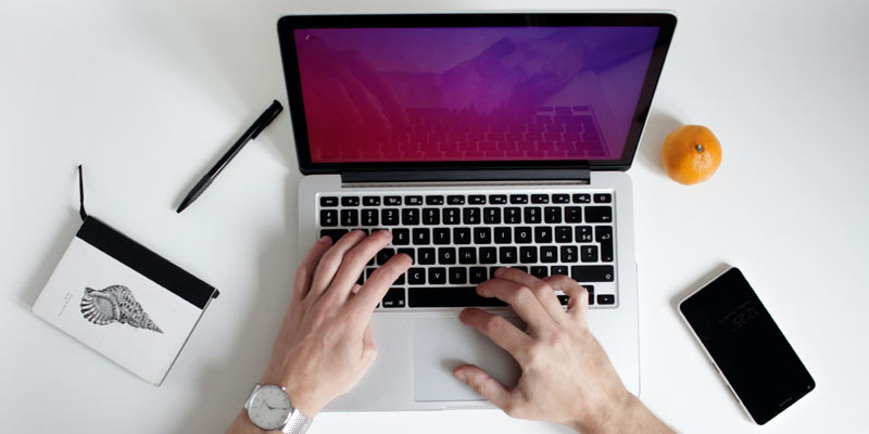 Mensch tippt auf Laptop